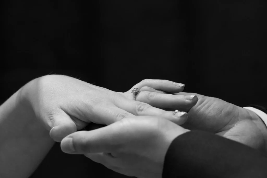 Groom placing a wedding ring on the bride’s finger during their ceremony in Osaka, Japan.