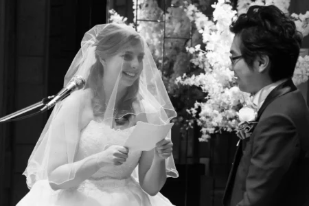 Bride reading personal wedding vows to the groom during their ceremony in Osaka, Japan. Bride reading personal wedding vows to the groom during their ceremony in Osaka, Japan.