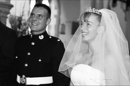 The bride and groom stand before the priest and exchange their vows. Bride and groom standing at the altar before the priest during their wedding vows.