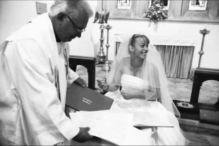 The bride signs the wedding register during the ceremony. Bride signing the wedding register during the wedding ceremony.