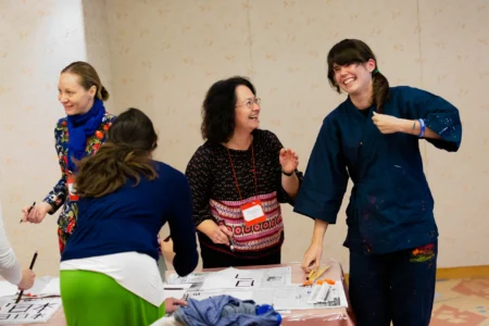 Conference attendees learn the Japanese art of calligraphy during a hands-on workshop led by calligraphy students from Ritsumeikan University. Japanese Calligraphy Workshop by Ritsumeikan Students