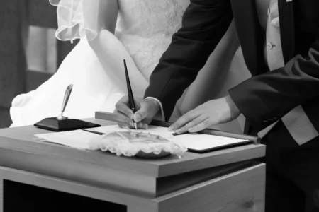 The groom signs the wedding register during their church ceremony. Groom signing the wedding register during his church wedding in Osaka, Japan.