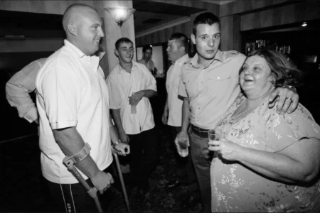 The groom celebrates with his mother and friends over drinks at the reception. Groom celebrating with his mother and friends over drinks at the wedding reception.