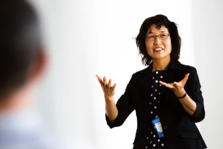 A presenter delivers an animated academic presentation at The European Conference on Language Learning (ECLL) in Brighton, UK. Academic Presentation at ECLL Brighton