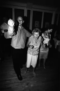 An elderly auntie is escorted to the dancefloor as the evening celebrations continue. Elderly auntie being escorted to the dancefloor during the wedding reception.