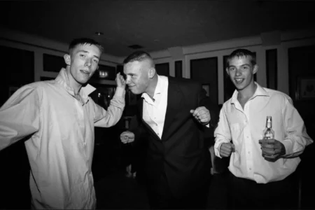 Friends fill the dancefloor as the wedding celebration carries on into the night. Friends dancing together at the wedding reception.