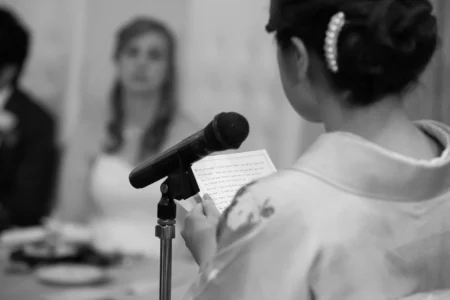 The bride’s best friend speaks to guests during the reception. Best friend of the bride speaking during their wedding reception in Osaka, Japan.