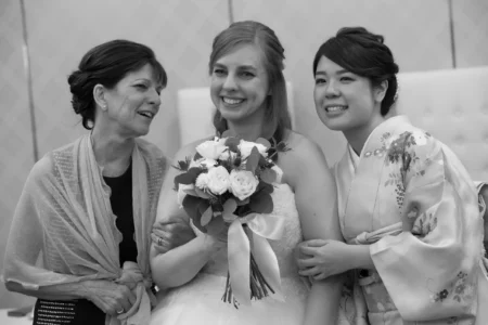The bride shares a moment with her mother and best friend. Bride with her mother and best friend during her wedding day in Osaka, Japan.