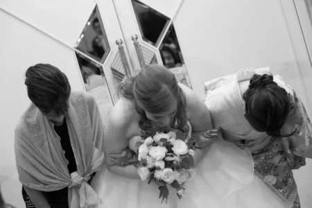 The bride, her mother and her best friend bow to guests during the reception. Bride, mother and best friend bowing to guests during her wedding reception in Osaka, Kansai, Japan.
