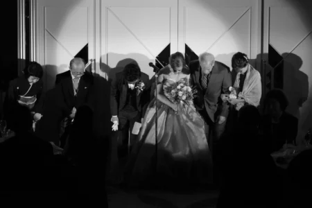The bride, groom and their families bow to guests at the end of the reception. Bride, groom and families bowing to guests during their wedding reception in Osaka, Kansai, Japan.